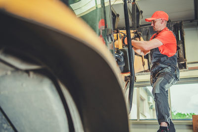 View of carpenter working indoors