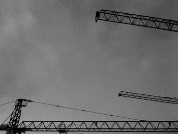 Low angle view of crane against sky