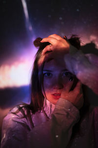 Close-up portrait of woman with reflection in water