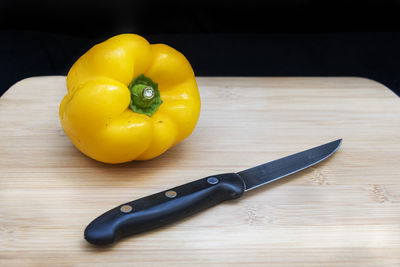 High angle view of yellow fruits on cutting board