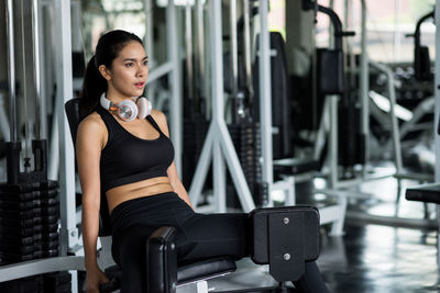 Thoughtful woman exercising in gym