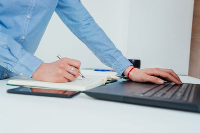 Low angle view of man using laptop on table