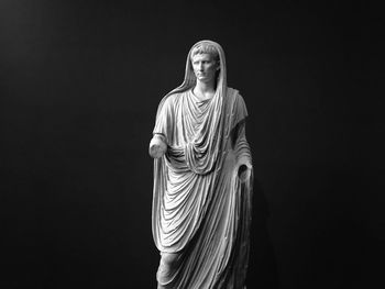 Low angle view of statue against black background