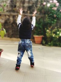 Rear view of a boy standing in park