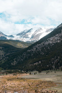 Scenic view of mountains against cloudy sky