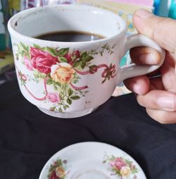 Close-up of hand holding tea cup