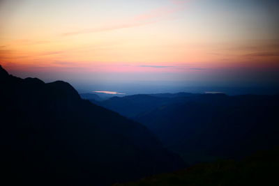 Scenic view of silhouette mountains against sky during sunset