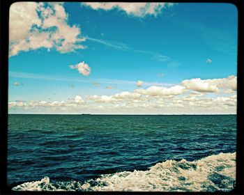 Scenic view of sea against cloudy sky