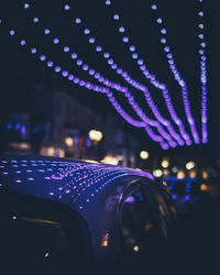 Close-up of illuminated lights in city at night