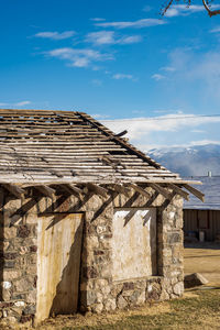 Exterior of old stone bathhouse building against sky