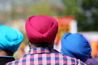 Rear view of men wearing turbans during sunny day
