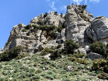 Low angle view of rock formation on mountain against sky