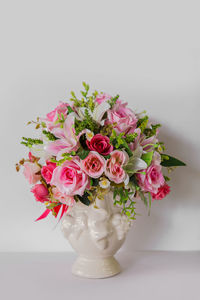 Close-up of pink roses in vase on table