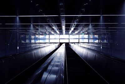 Illuminated escalator at night