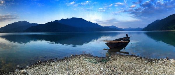 Scenic view of lake and mountains against sky