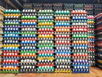 Lots of chicken eggs on colorful plastic crates for sale backgrounds at indian market