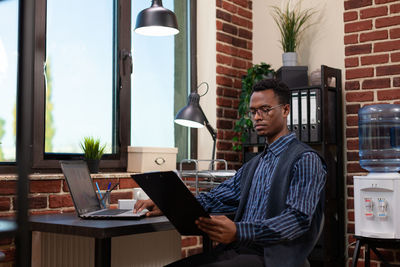 Businessman examining reports at office