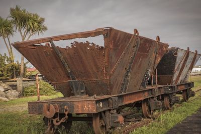 Close-up of rusty metal against sky