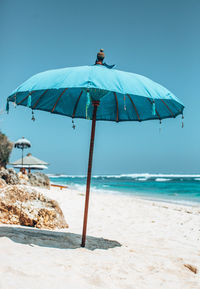 Lifeguard hut on beach against clear sky