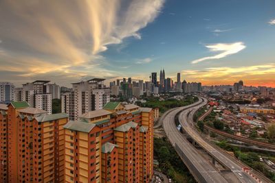 High angle view of road and buildings against sky at dusk in city