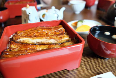 High angle view of fried saltwater eels in container on table