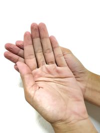 Close-up of human hand against white background