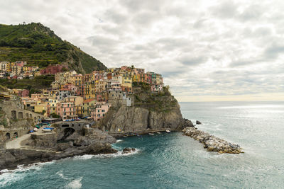 Manarola landscape with colorfull tiny house on the sea on a cloudy day