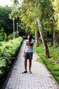 Rear view of woman walking on footpath