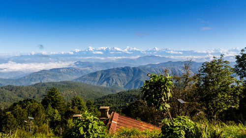 Scenic view of mountains against blue sky