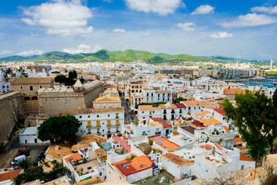 High angle view of town against cloudy sky