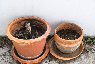 Twin clay pot with the soil for planting trees on the terrace of the office building.