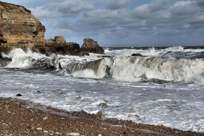 Scenic view of sea against cloudy sky