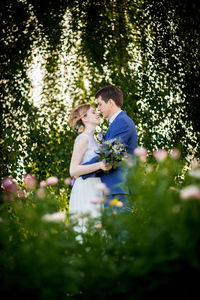 Bride and bridegroom romancing at park