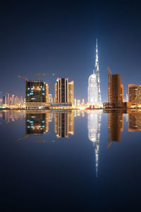 Reflection of buildings in city at night