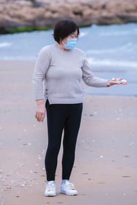 Full length of woman standing on beach