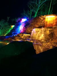 Illuminated light trails on water at night