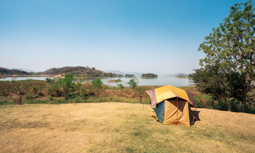 Tourist tent and vacation blue sky, camping with nature of river and mountain.
