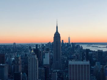 View of buildings in city at sunset