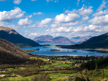 Scenic view of lake and mountains against sky