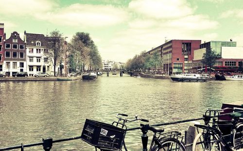 Boats in river with buildings in background