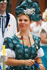 Portrait of a smiling young woman holding camera