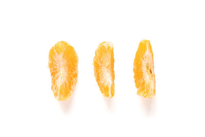 Close-up of orange fruit against white background