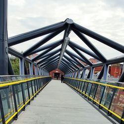 Bridge against cloudy sky