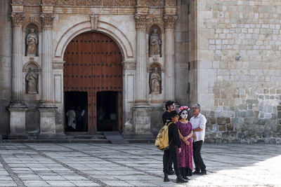 Full length of woman standing at historical building