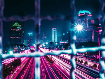 High angle view of illuminated light trails on building at night