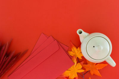 High angle view of electric lamp on table against red background