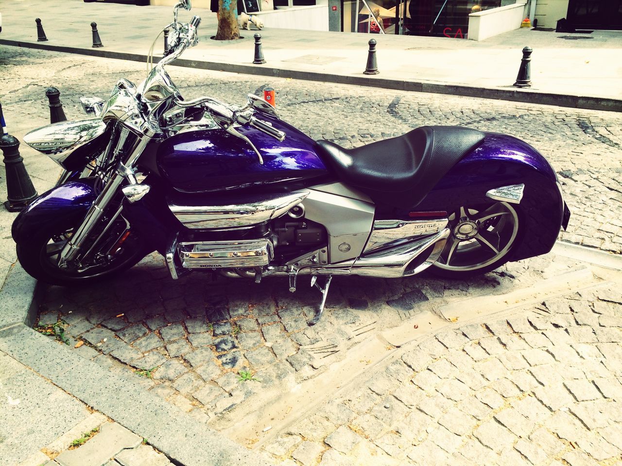 land vehicle, transportation, mode of transport, street, bicycle, stationary, parking, car, parked, road, sidewalk, cobblestone, outdoors, day, sunlight, shadow, city, motorcycle, parking lot, travel