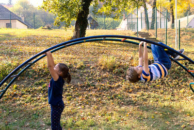 Rear view of father and daughter in park