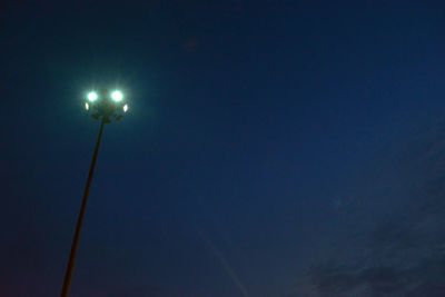 Low angle view of illuminated street light against clear sky