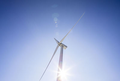 Wind turbine low angle against blue sky